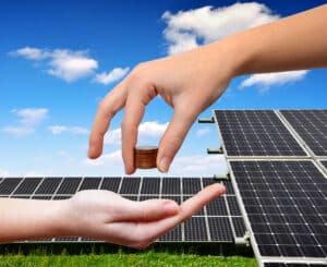 solar panels and coins in hand